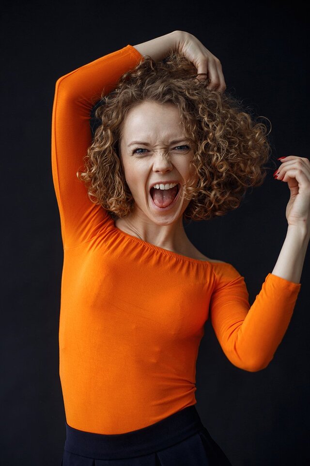 Facial expression, Orange, Arm, Shoulder, Gesture, Fun, Smile, Joint, Hand