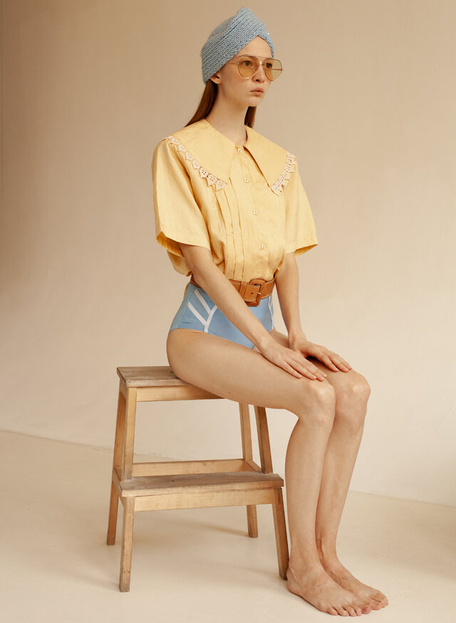 Clothing, Sitting, Shoulder, Yellow, Leg, Joint, Fashion, Beige, Knee